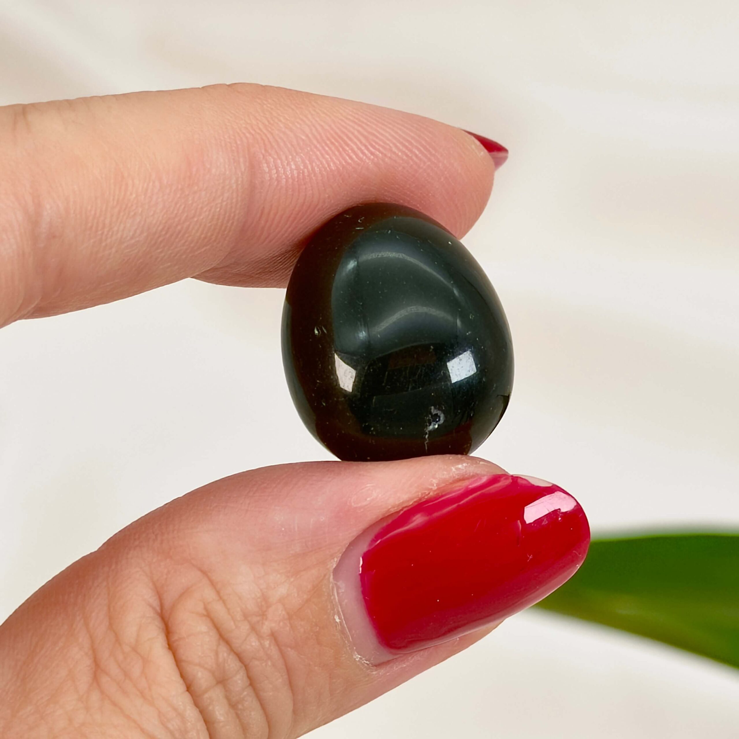 Obsidian Sort Lommesten Krystal Sten samling i hånd på hvid baggrund