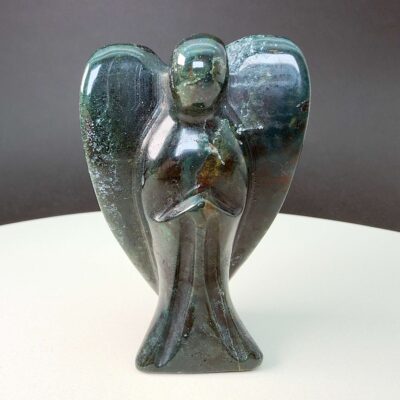 Agat mos krystal engel på hvid plade med sort baggrund