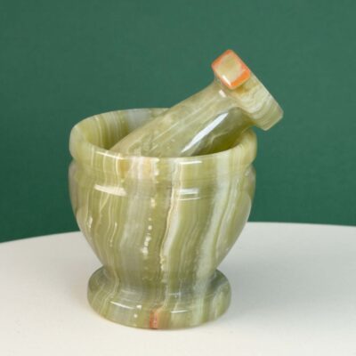 Pakistani Onyx Morter krystal sten på hvid og grøn baggrund