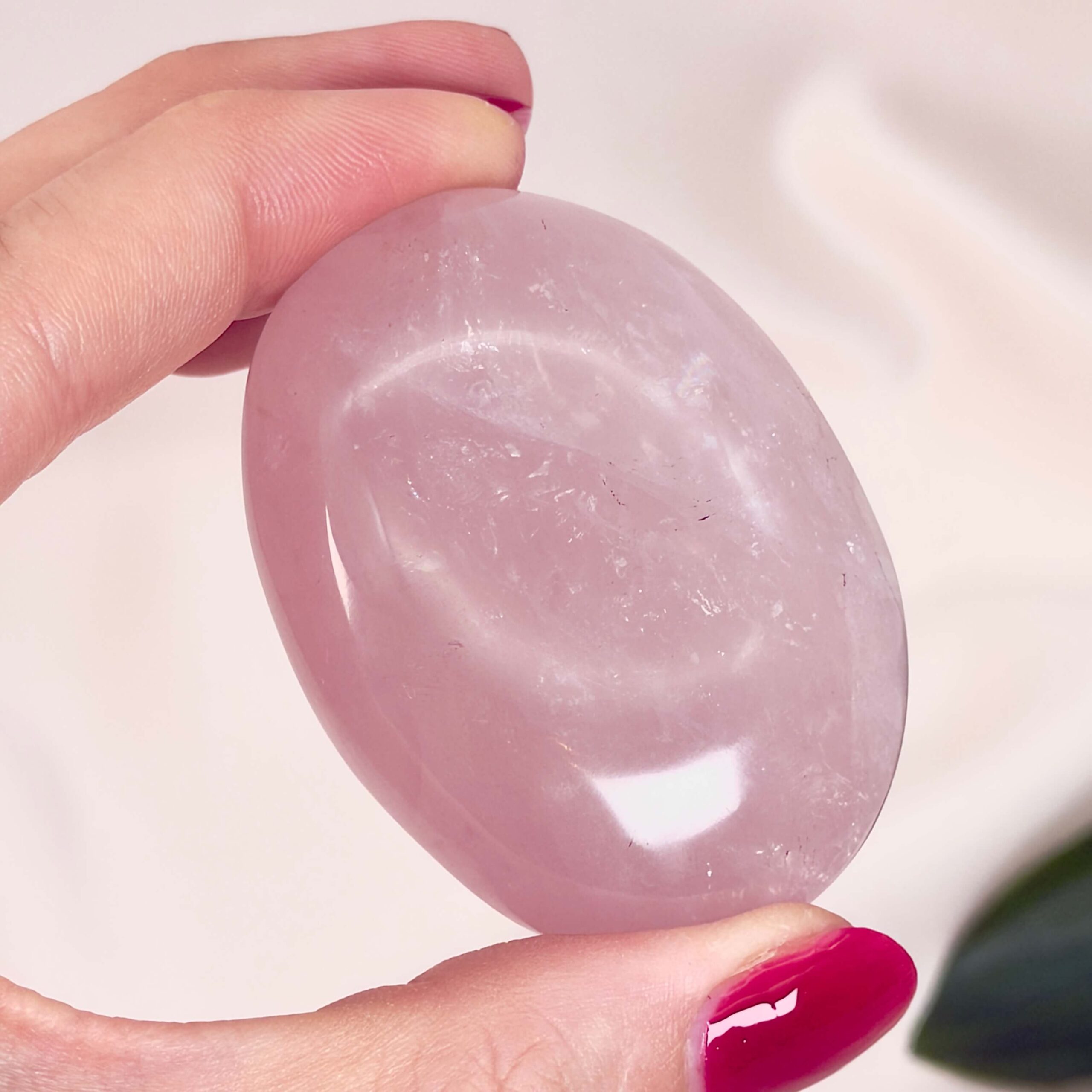 Rosakvarts Håndsten Krystal Sten i hånd på hvid baggrund