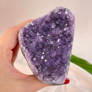 Ametyst Premium Grotte Krystal Sten i hånd på hvid baggrund