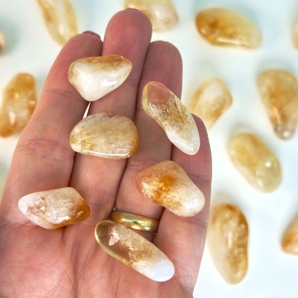 Citrin Lommesten krystal sten i hånd på hvid baggrund