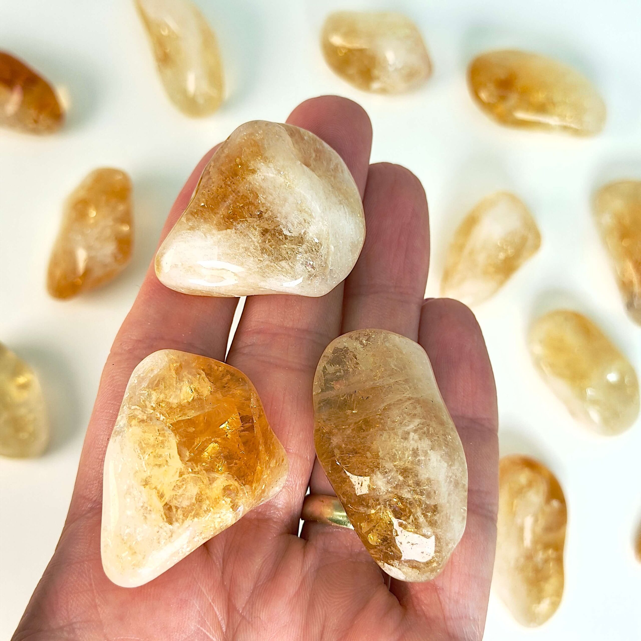 Citrin Lommesten krystal sten i hånd på hvid baggrund