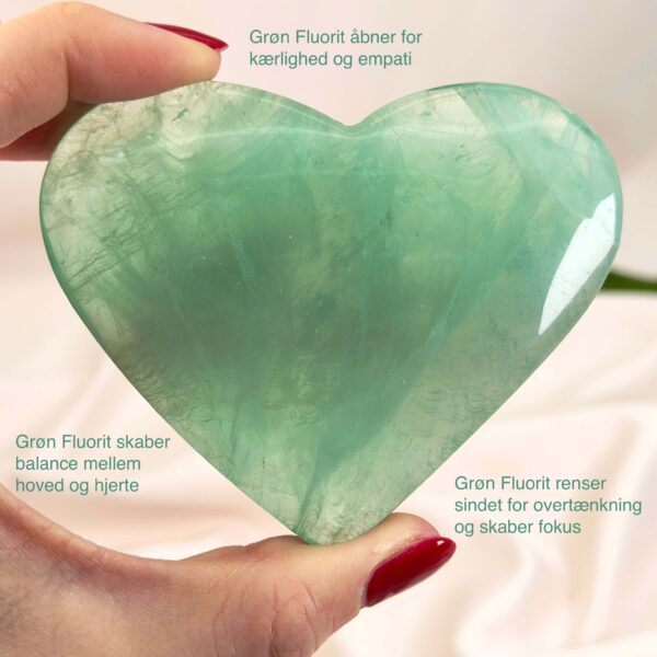 Fluorit Grøn Hjerte Krystal Sten i hånd hvid baggrund med tags