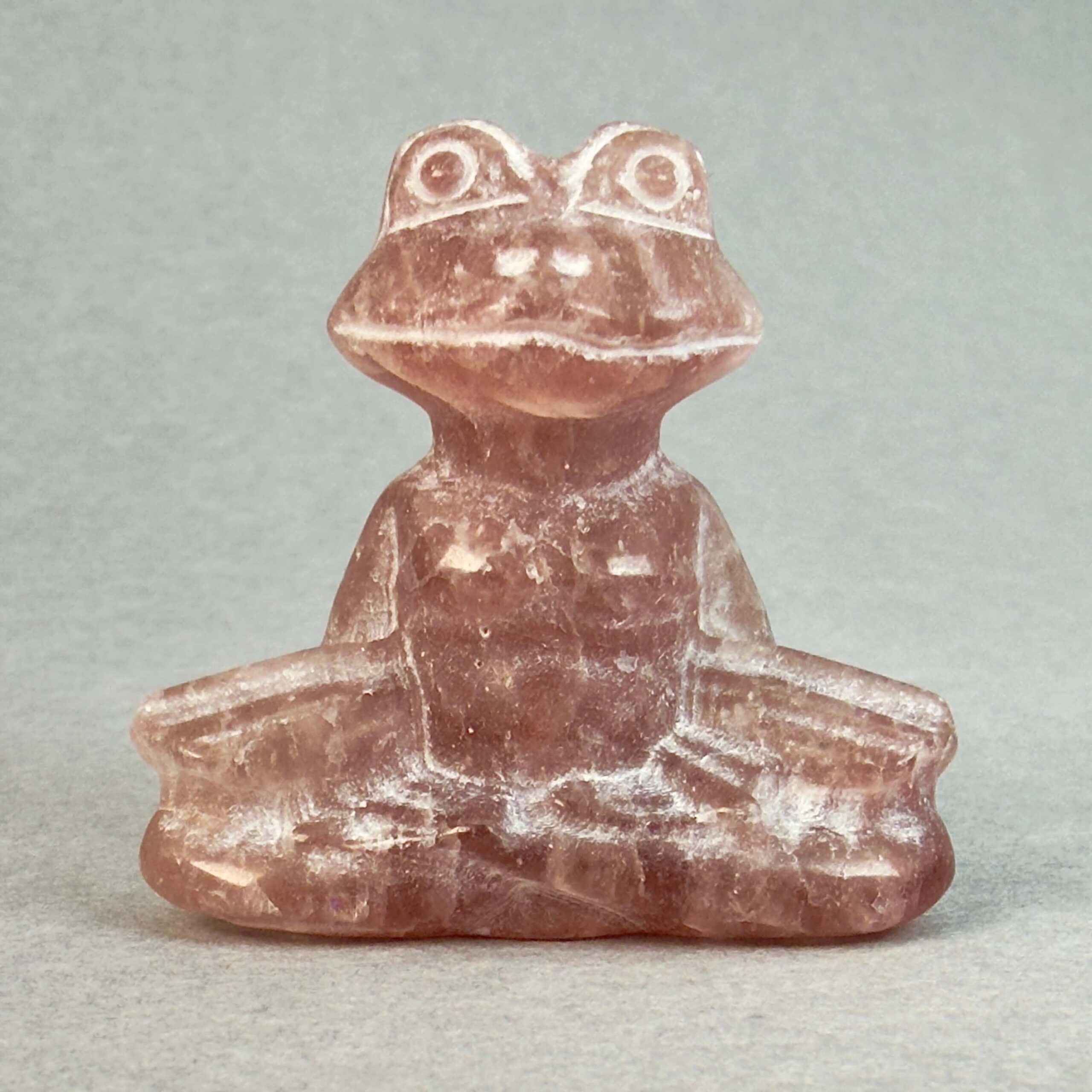 Krystal meditationsfrø 4 cm jordbærkvarts på grå baggrund