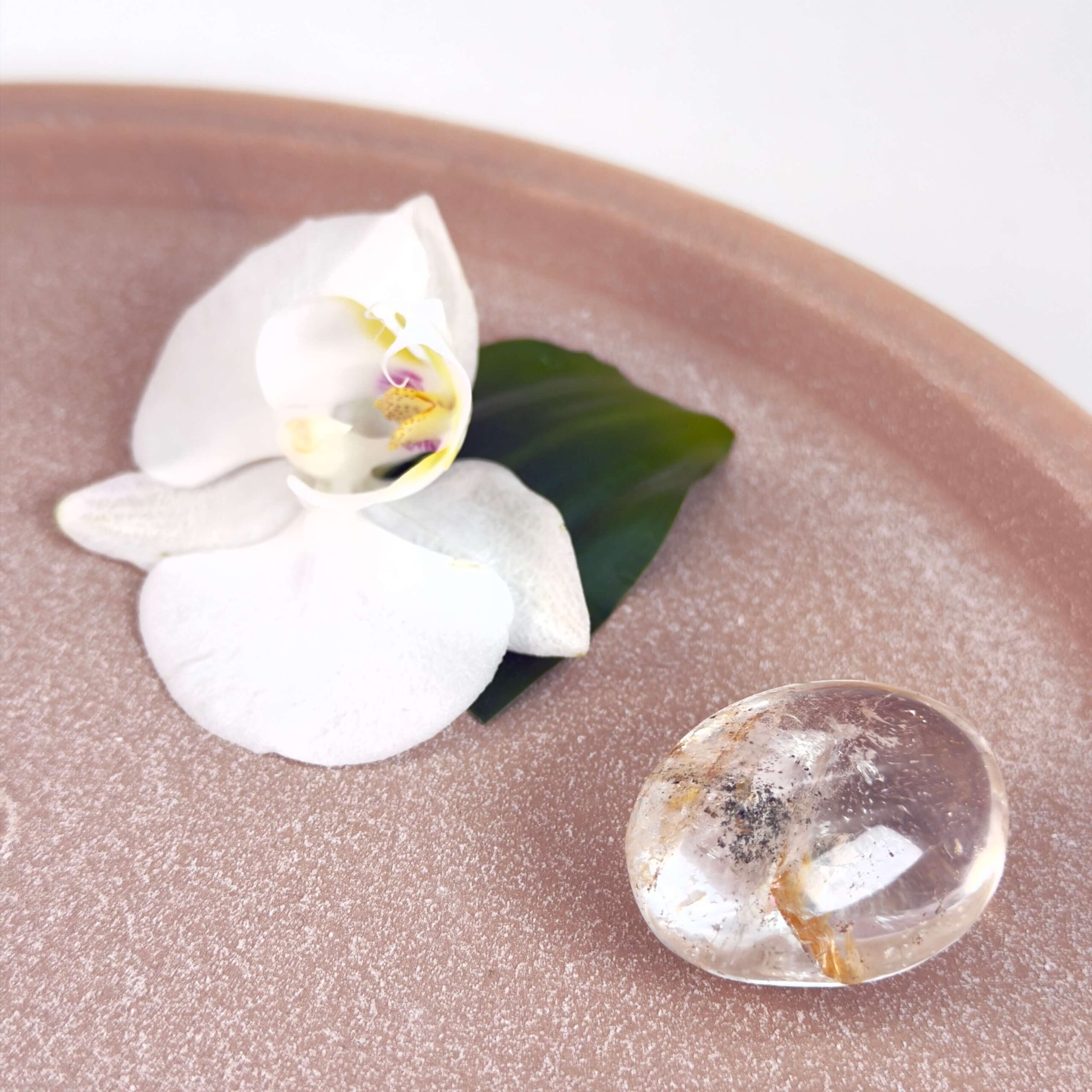 Bjergkrystal Poleret Sten krystal sten på fad på hvid baggrund