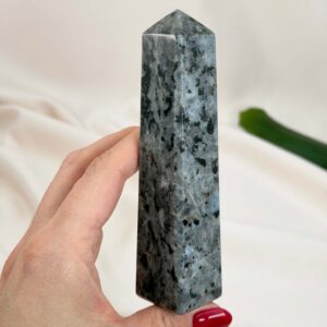 Larvikit Tårn krystal sten i hånd på hvid baggrund