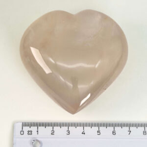 Rosakvarts Hjerte Krystal Sten på hvid baggrund med lineal