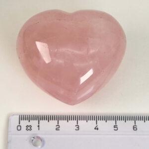 Rosakvarts Hjerte Krystal Sten på hvid baggrund med lineal
