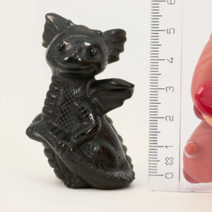 Sort Obsidian Babydrage Krystal sten med lineal på hvid baggrund