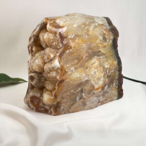 Agat lampe med naturlige mønstre og farvespil, der udsender et varmt og roligt lys i rummet.