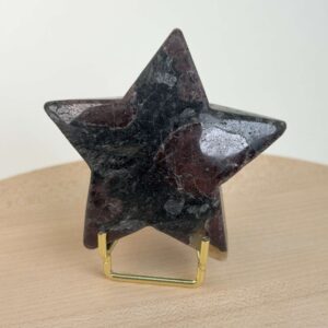 Granat stjerne med dybrøde nuancer og energi for styrke, motivation, grounding og personlig udvikling.