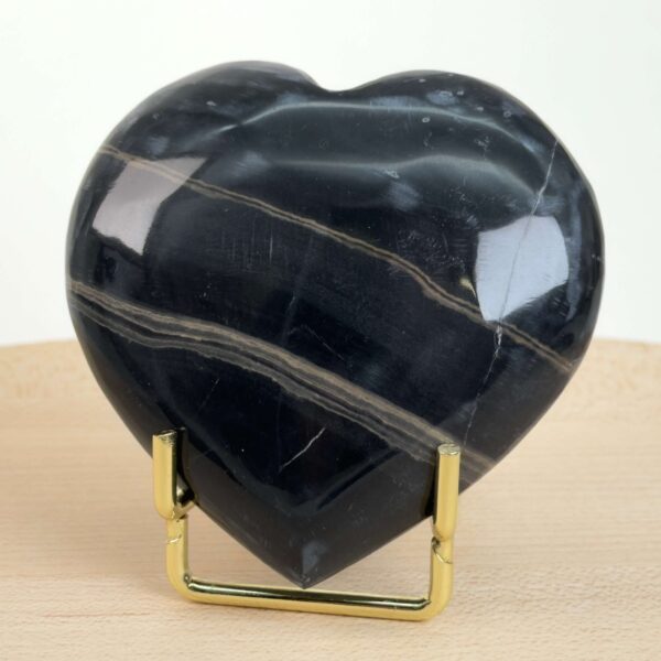 Sort Båndet Onyx hjerte med naturlige sorte, grå og hvide bånd, der symboliserer grounding, beskyttelse og indre styrke.