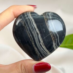 Sort Båndet Onyx hjerte med naturlige sorte, grå og hvide bånd, der symboliserer grounding, beskyttelse og indre styrke.