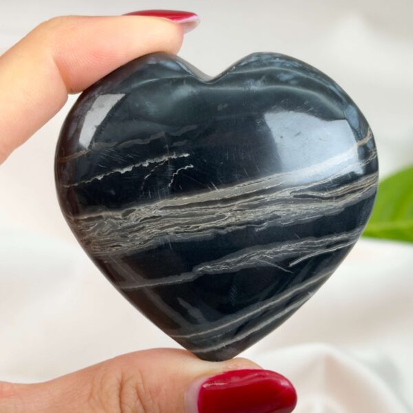 Sort Båndet Onyx hjerte med naturlige sorte, grå og hvide bånd, der symboliserer grounding, beskyttelse og indre styrke.