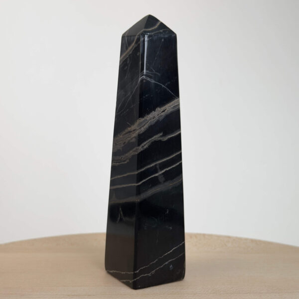 Sort Båndet Onyx tårn med naturlige sorte, grå og hvide bånd, der symboliserer grounding, beskyttelse og indre styrke.