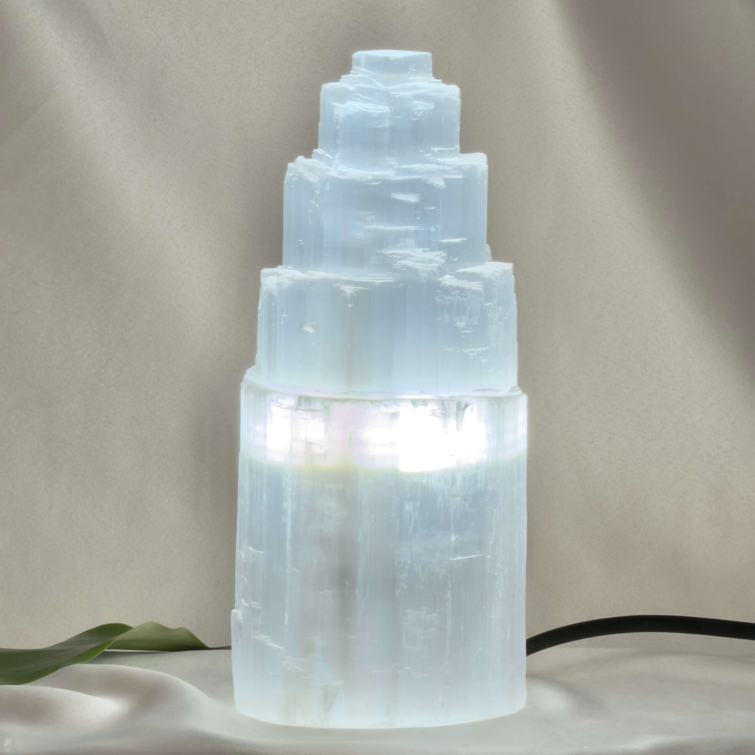 Selenit Tårn Lampe Nr. XX tændt med varmt lys gennem den naturlige Selenit